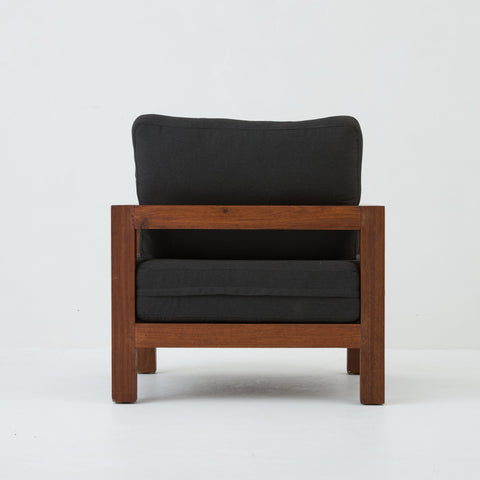 Back view of Cali teak armchair with coal cushions