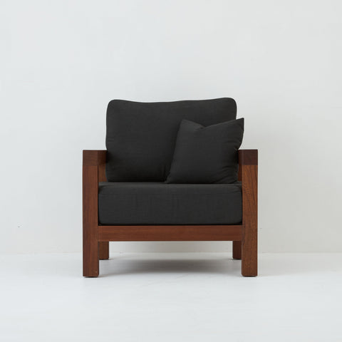 Front view of Cali teak armchair with coal cushions