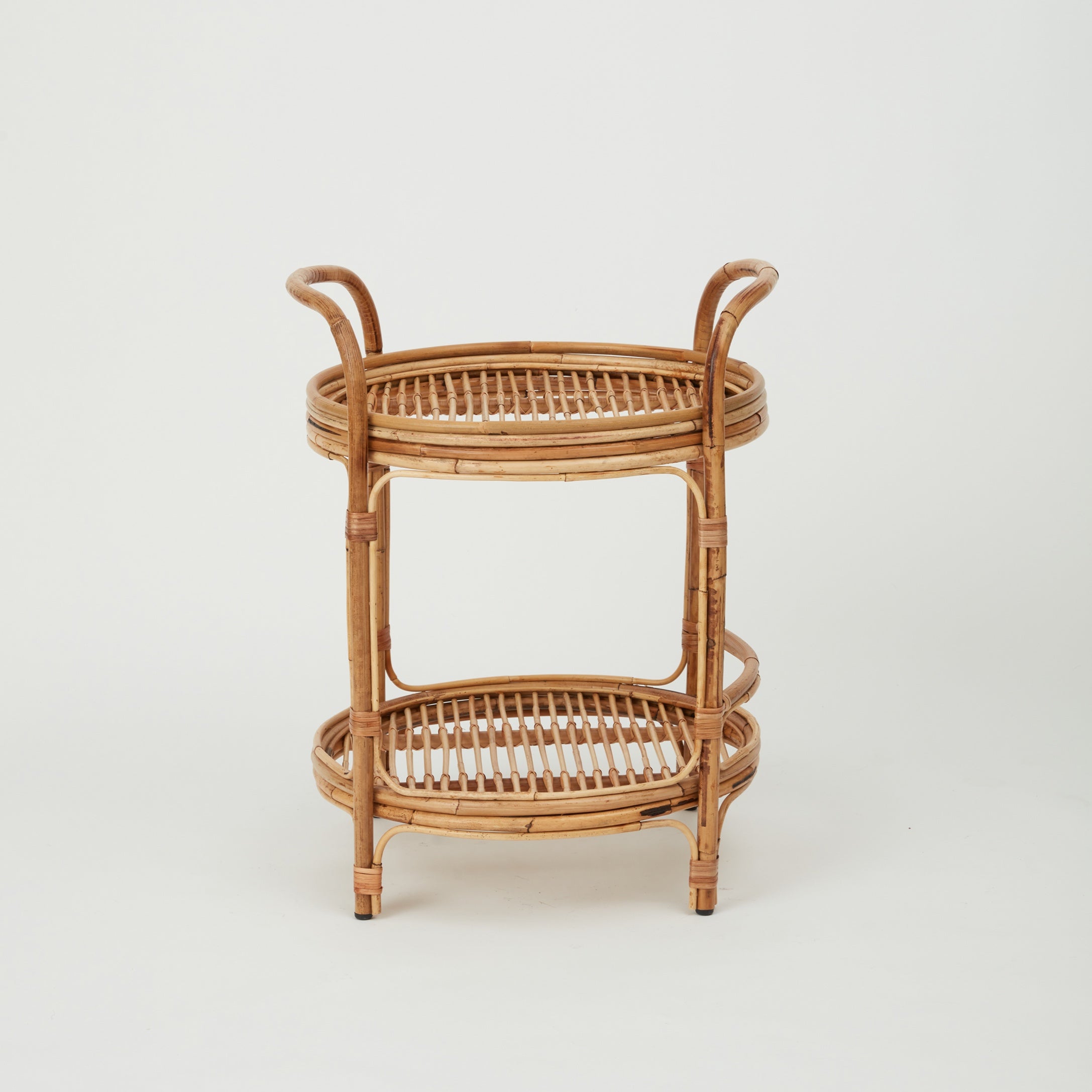 Capri rattan bar trolley with two glass-top shelves, perfect for serving drinks.