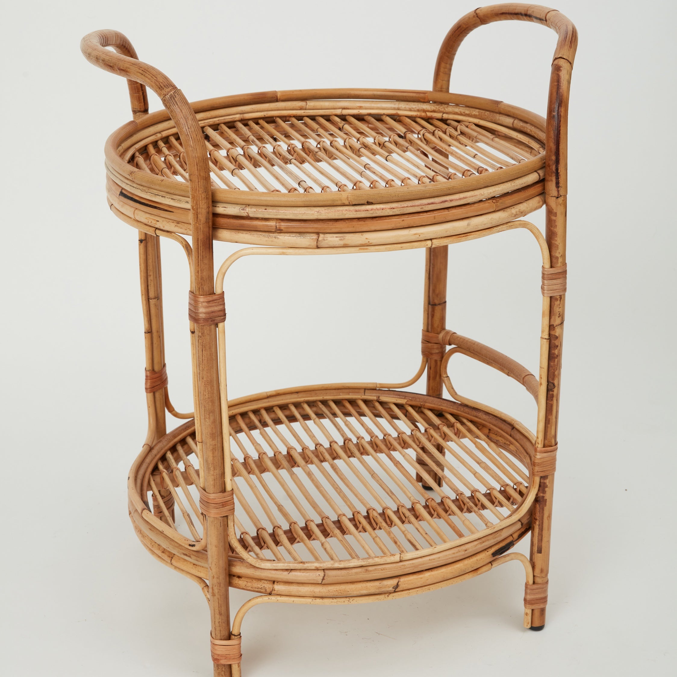 Side view of the Capri rattan bar trolley with two glass-top shelves