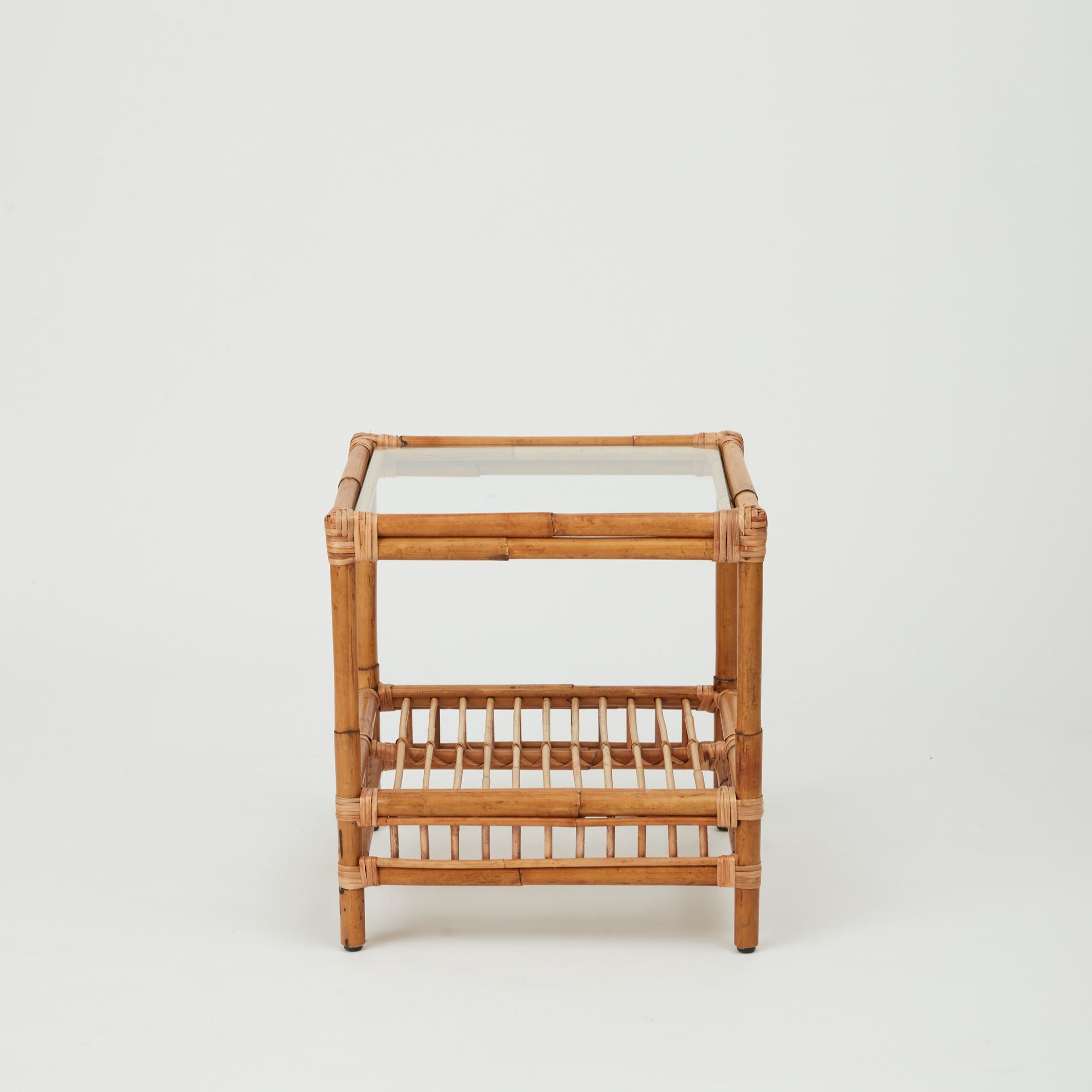 Capri rattan side table with glass top and lower rattan shelf, natural finish.