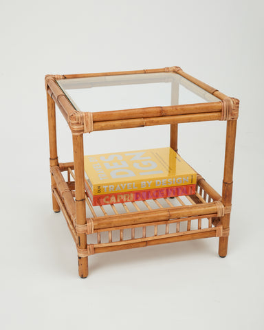 Side view of the Capri rattan side table with glass top styled with books