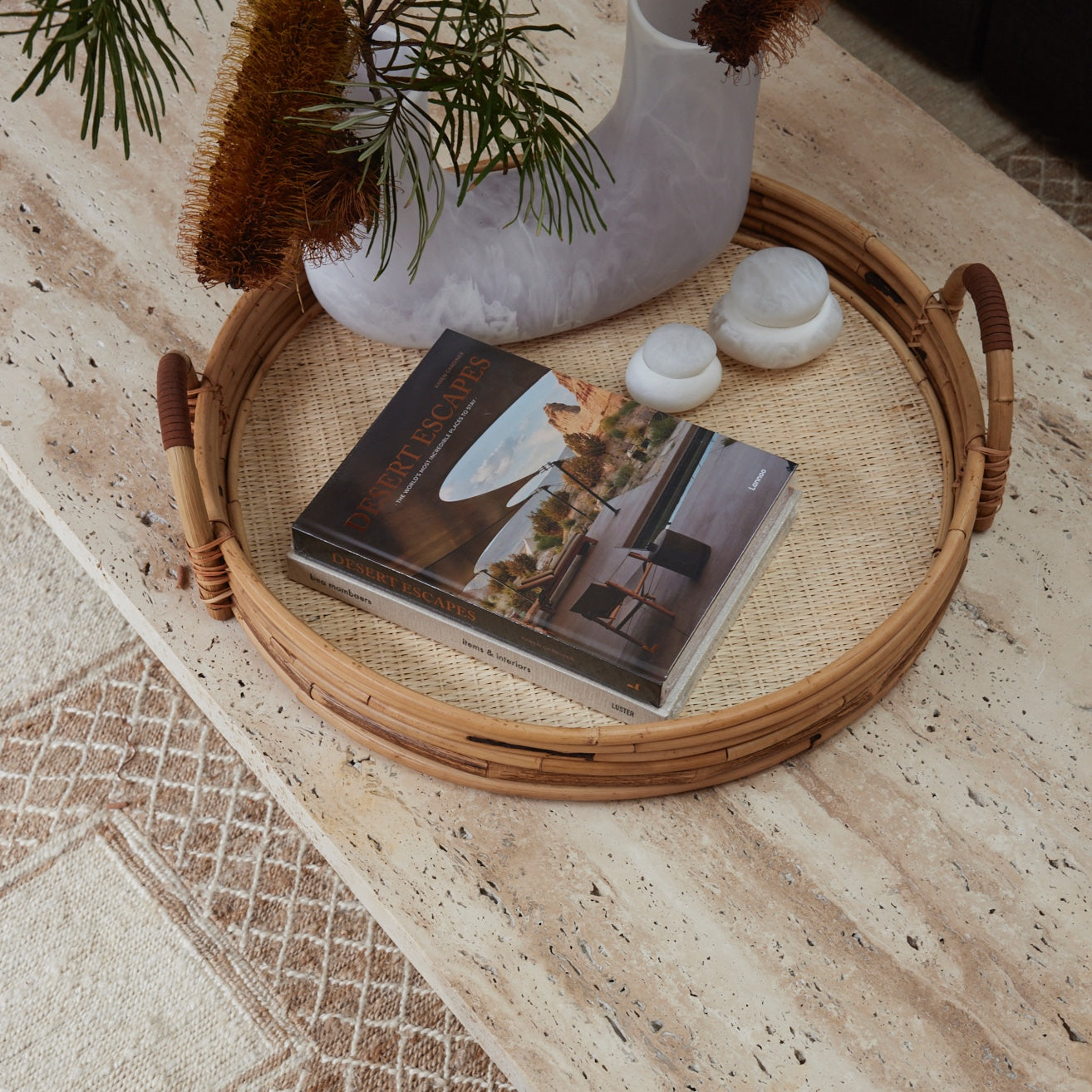 Cuba rattan tray styled on a coffee table with books and vase showcasing its natural woven texture.