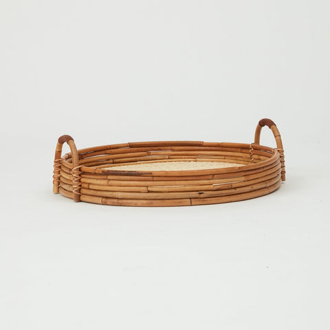 Cuba round serving tray in natural rattan, woven base with raised edges.