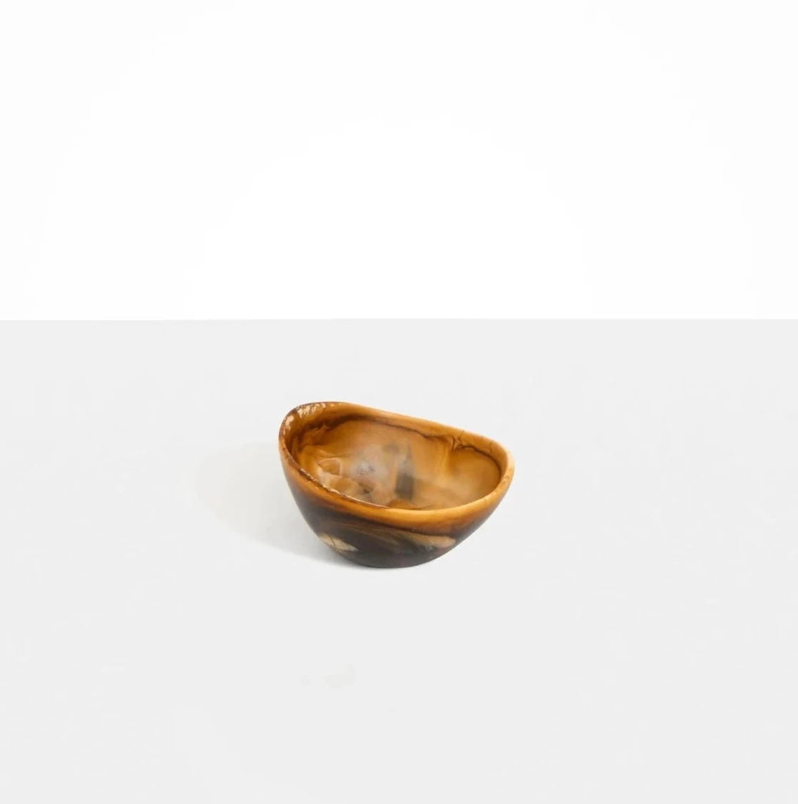 Dinosaur Designs Flow Spice Dish in Dark Horn resin with curved organic shape.