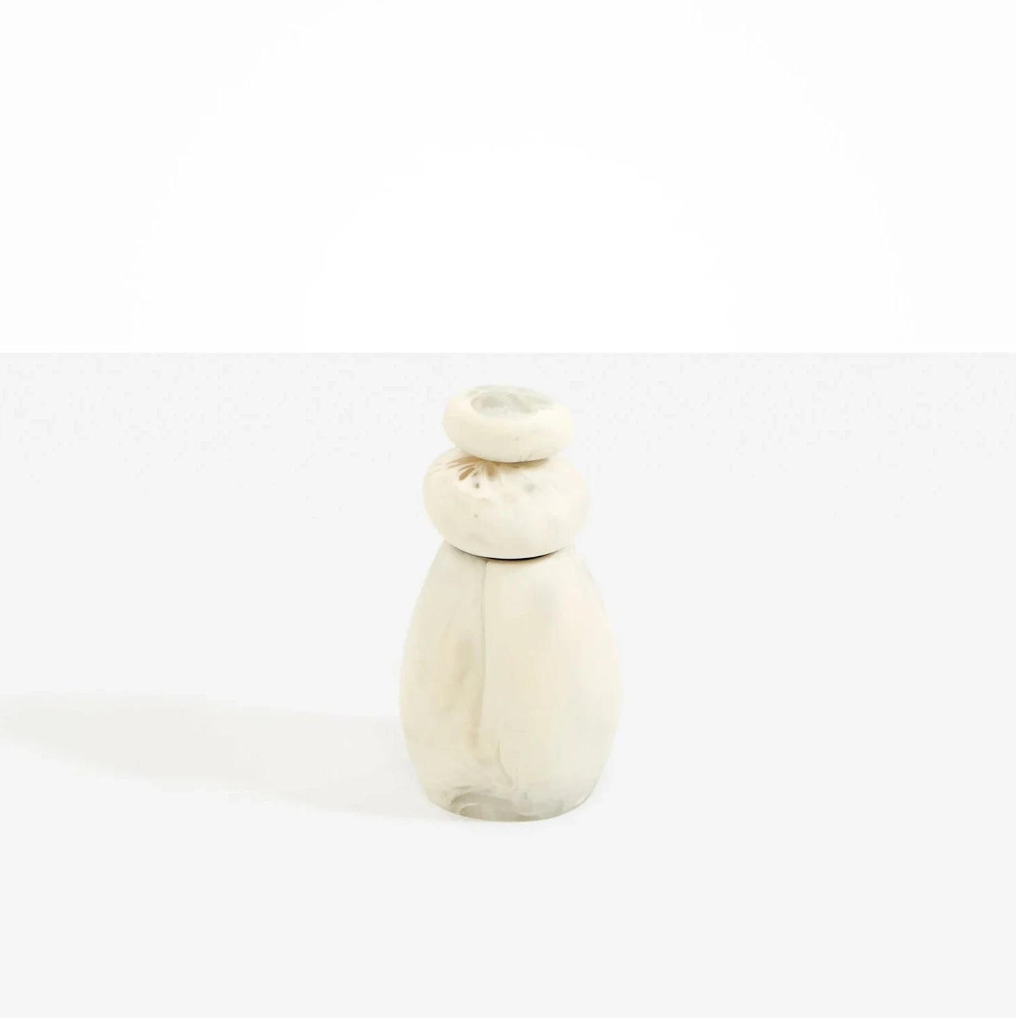 Dinosaur Designs Boulder Pepper Grinder in Swirl Chalk resin with sculptural pebble shape.