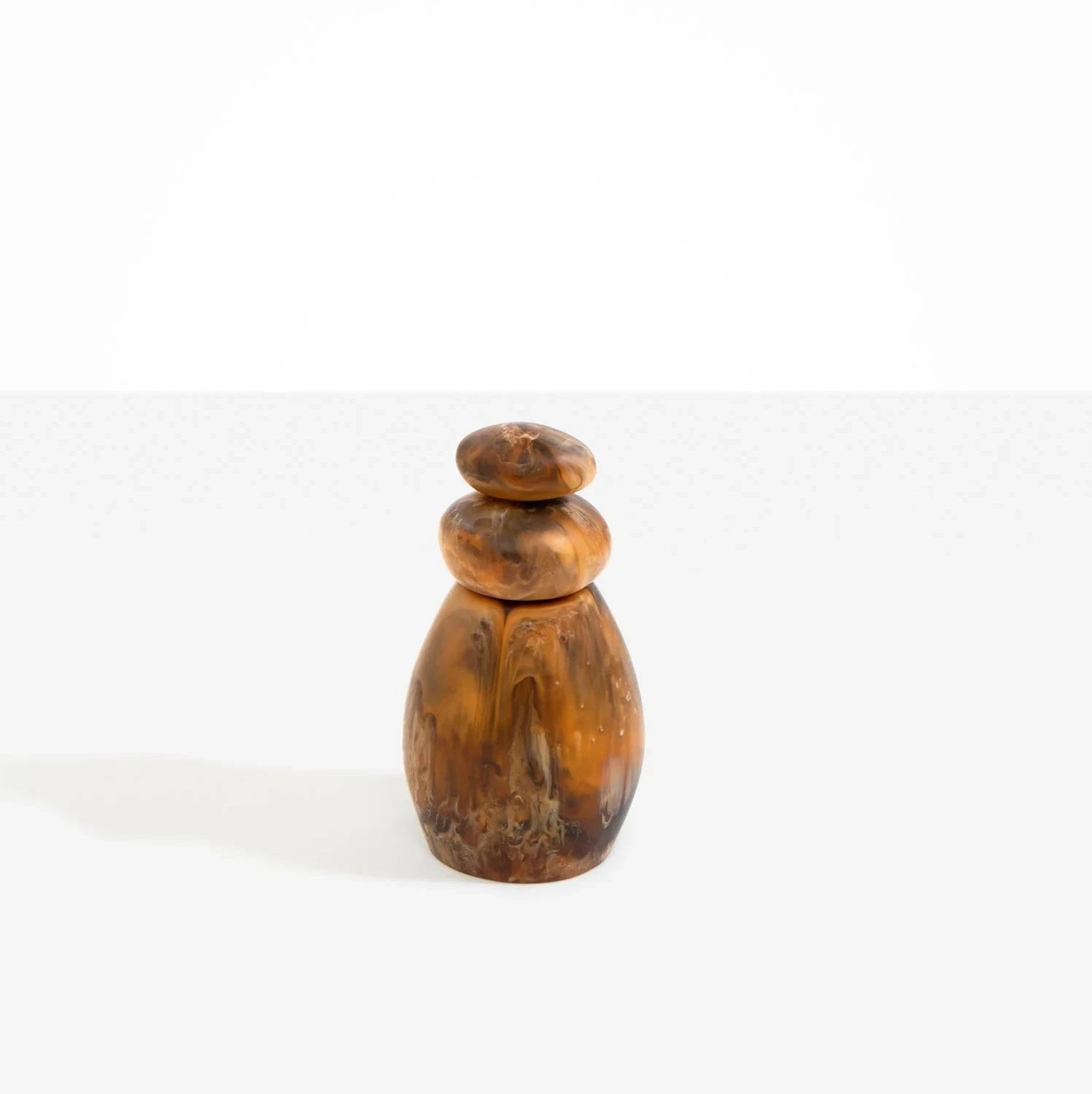 Dinosaur Designs Boulder Pepper Grinder in Dark Horn resin with sculptural pebble shape.