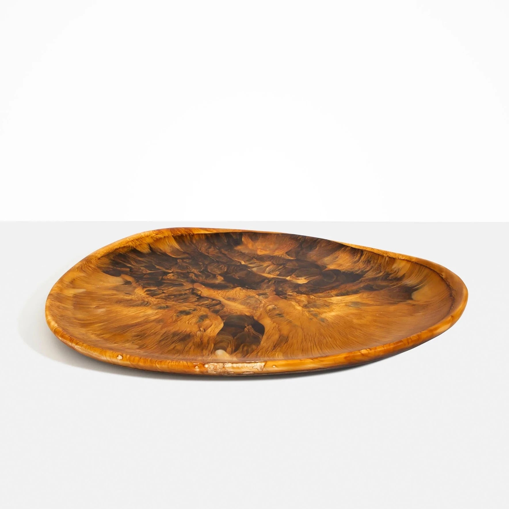 Dinosaur Designs Large Pebble Platter in Dark Horn resin with rich marbled swirls and organic form.