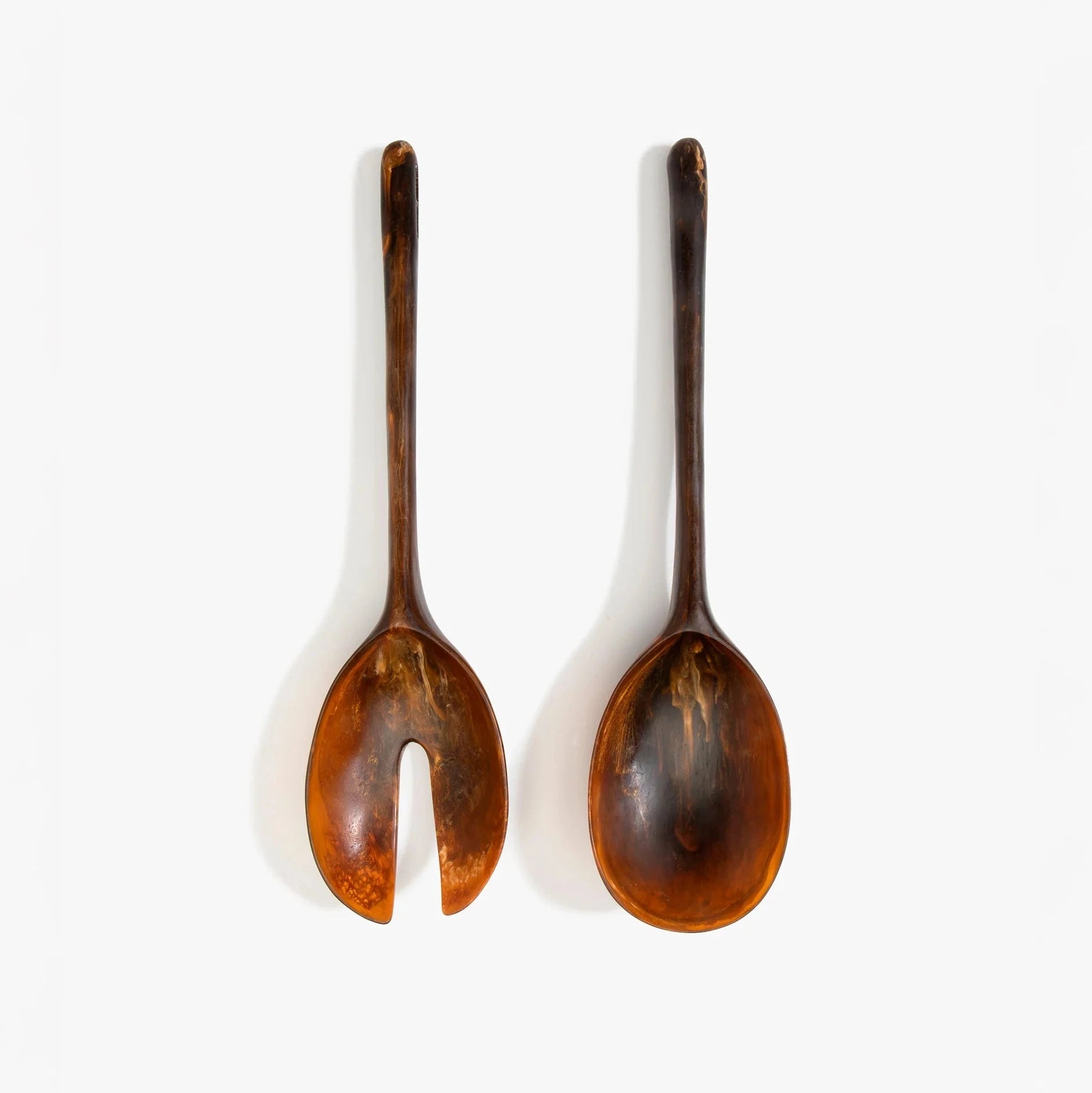 Dinosaur Designs Long Stone Servers in Dark Horn resin with sculptural spoon-like shape.