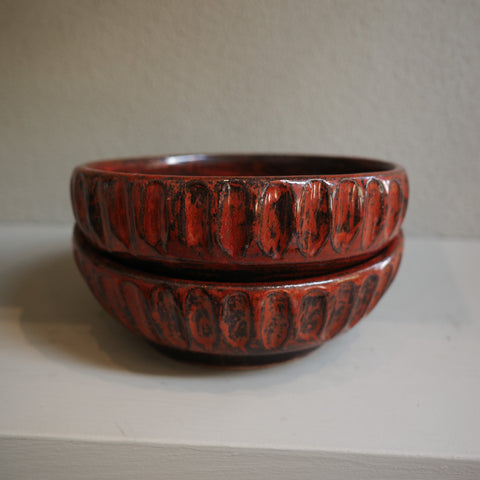 Stacked view of copper float fluted ceramic bowls showing glaze texture and handmade details