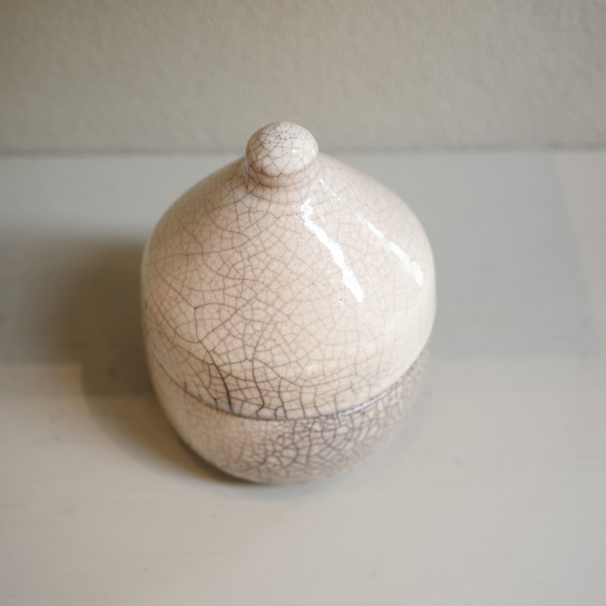 Handmade glazed Raku canister with domed lid and crackle finish by Mullumbimby artist Jacqui Sosnowski.