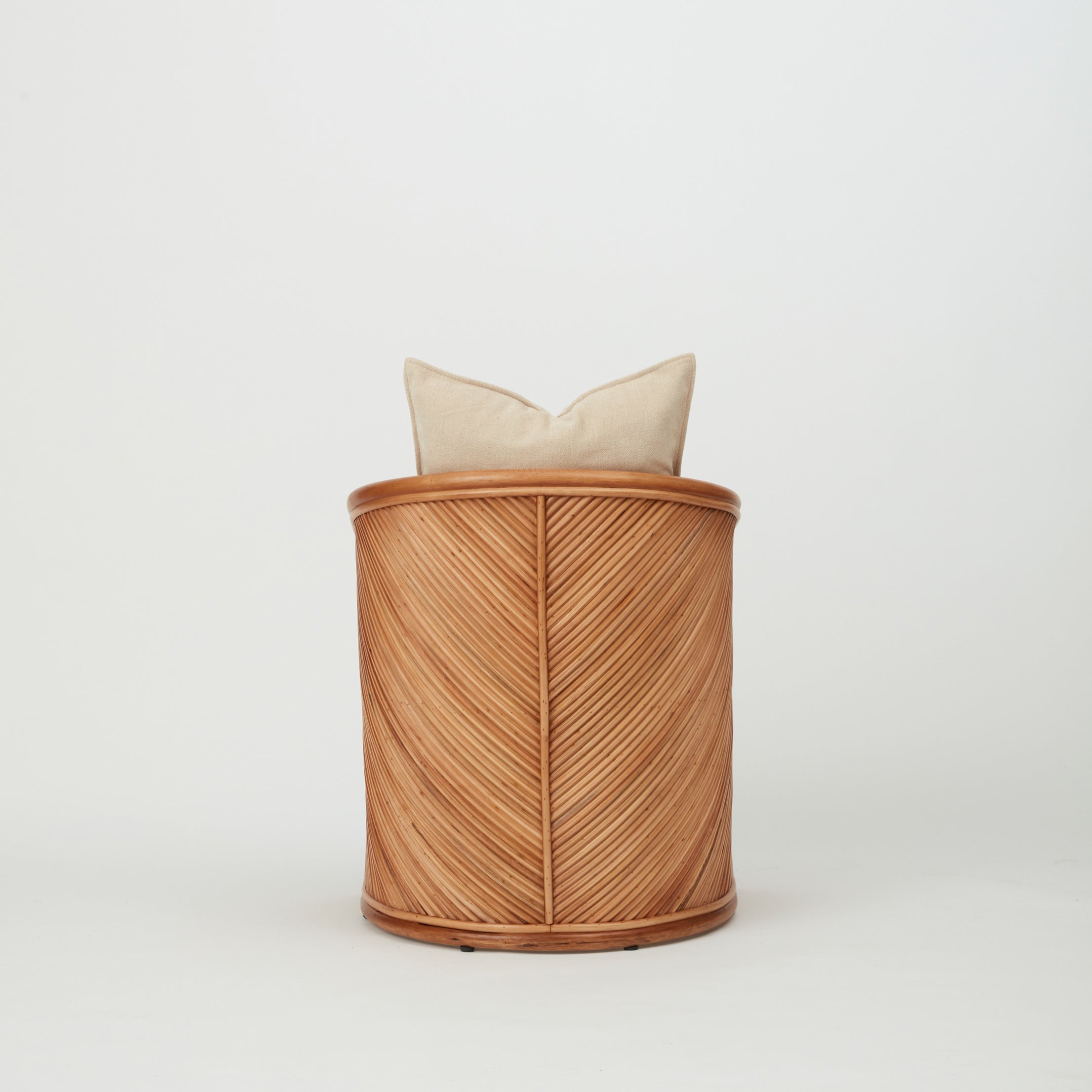 Close-up of Grace dining chair showing diagonal rattan weaving and warm natural finish.