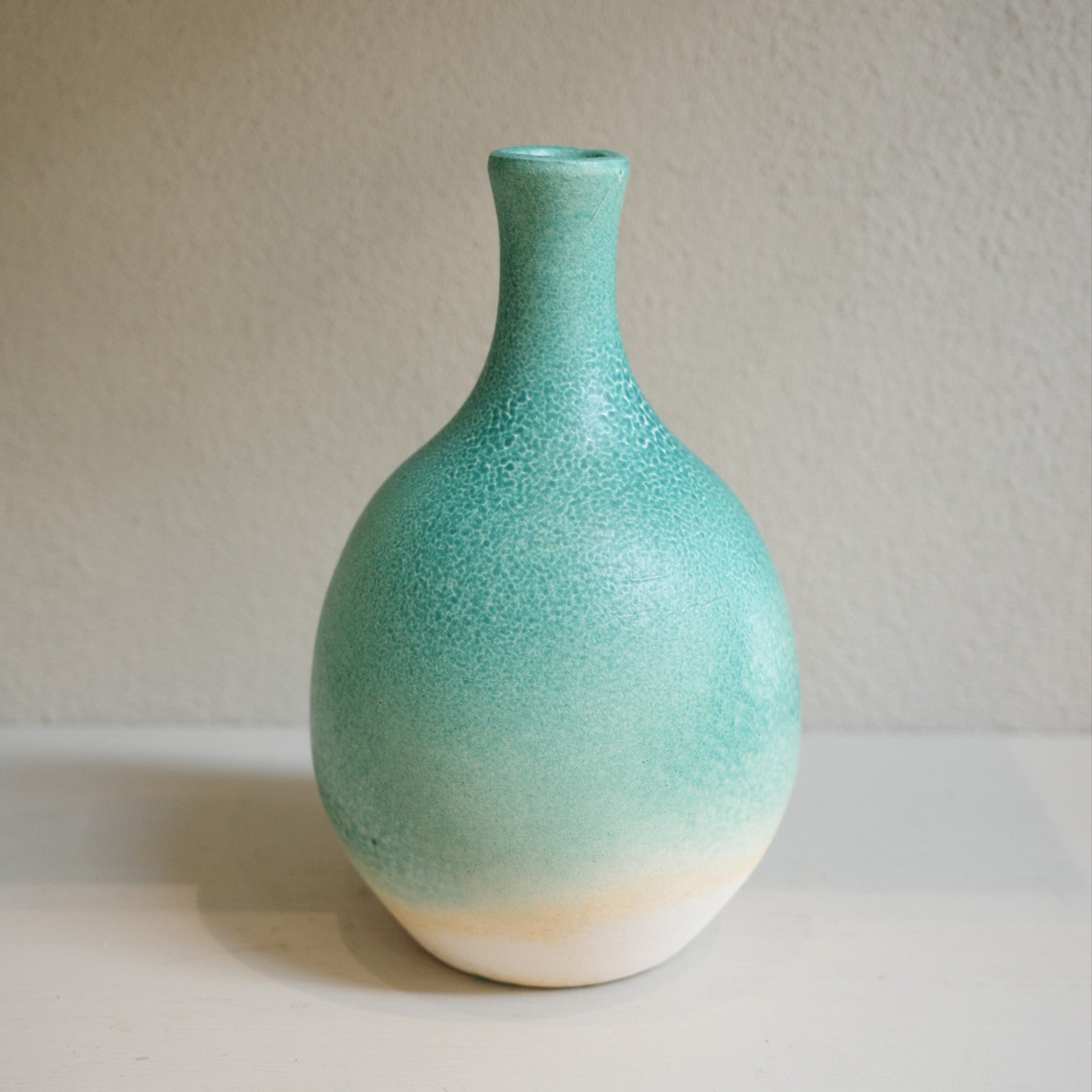 Handmade ceramic bottle-neck vase with green ombré glaze, created by Australian artist Jacqui Sosnowski.