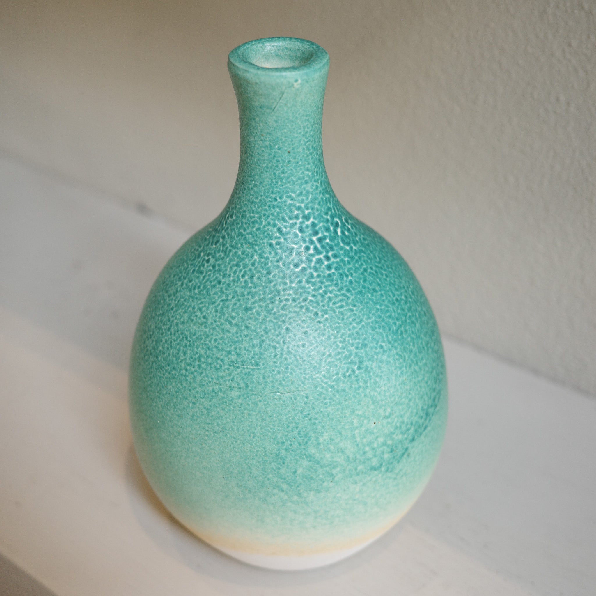 Handmade ceramic bottle-neck vase with green ombré glaze, created by Australian artist Jacqui Sosnowski.