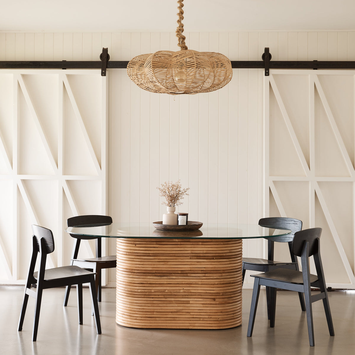 Laguna oval dining table in natural rattan with glass top