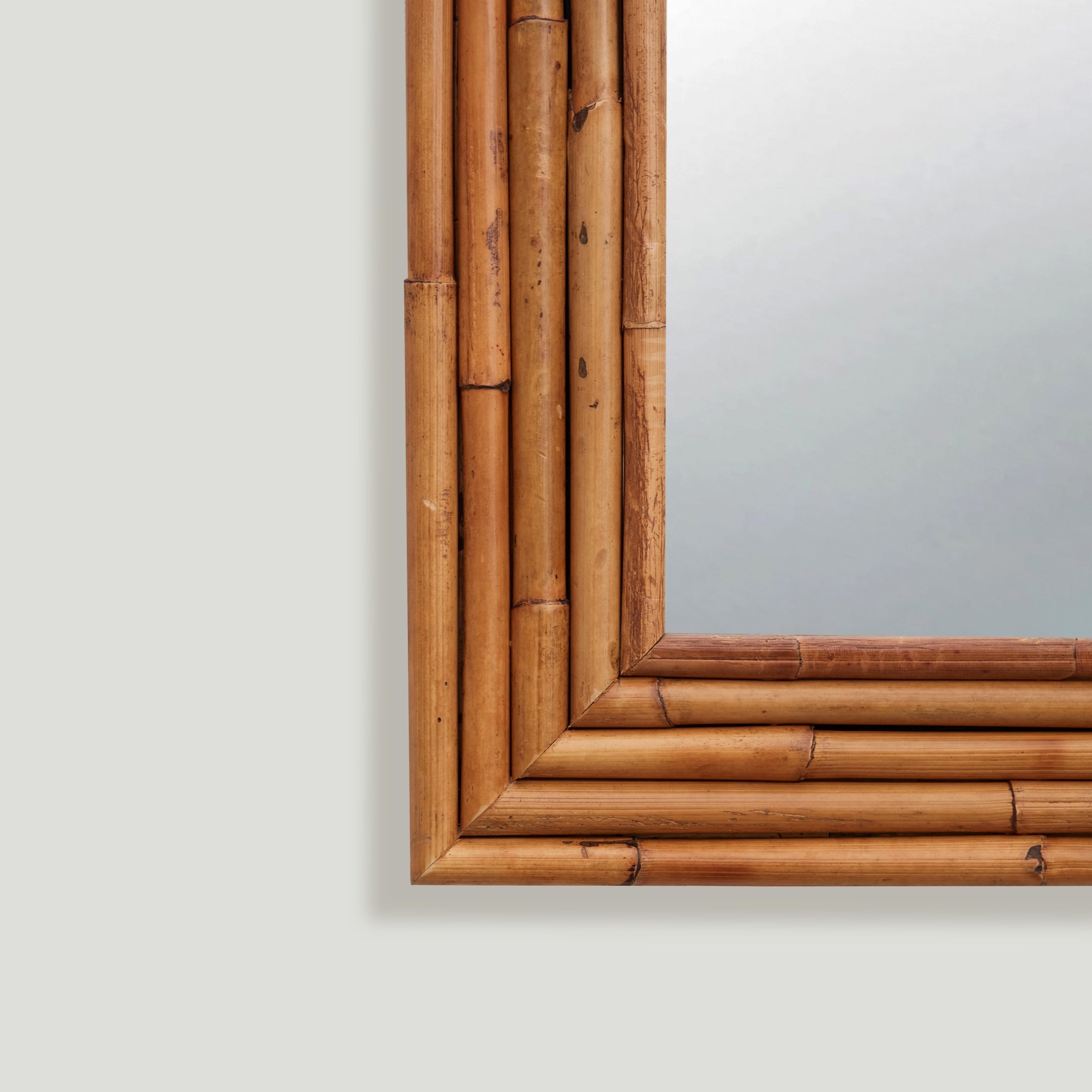 Full-lenght rattan mirror styled in a living room