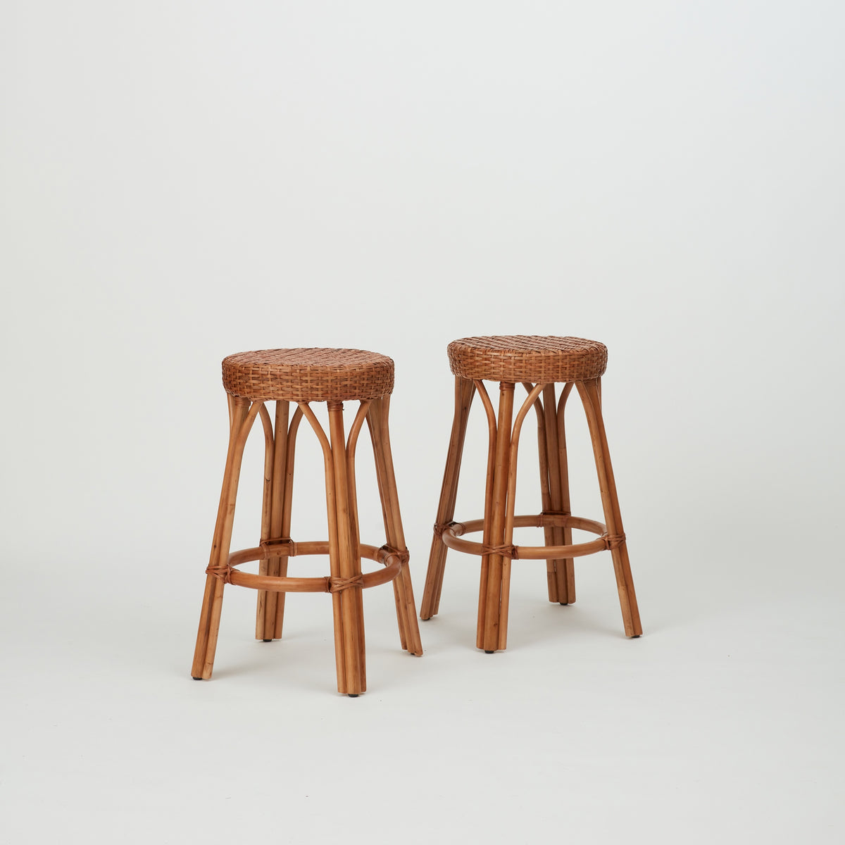 Two Leila Rattan Bar Stools in natural finish, with handwoven seats 