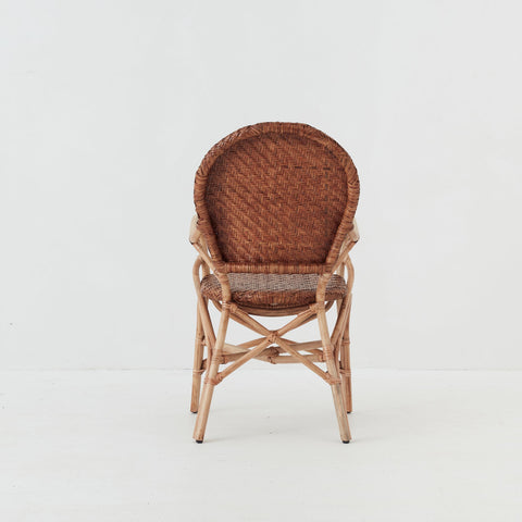 Leila dining chair with handwoven rattan seat and backrest on a natural rattan frame, back view.