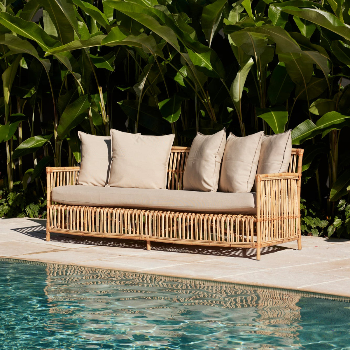 Lene Rattan Sofa in outdoor Ibiza Beige fabric styled outdoor