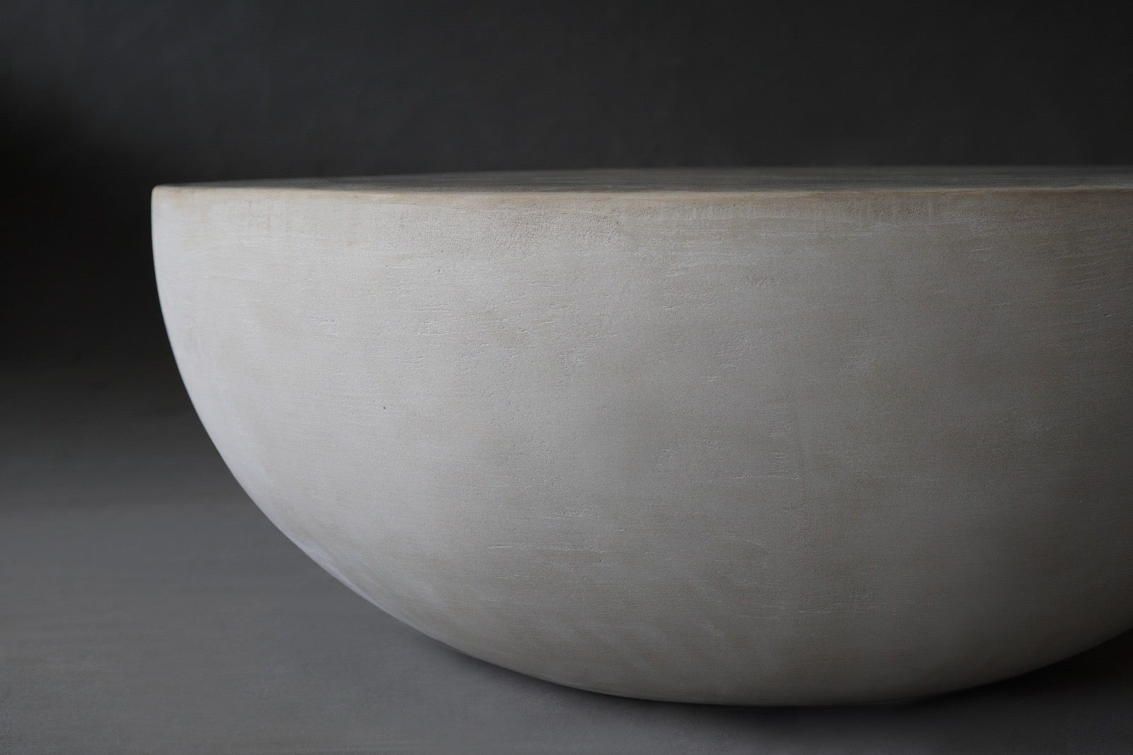 Close-up view of the Moon Coffee Table in 900 Diameter in Oyster finish