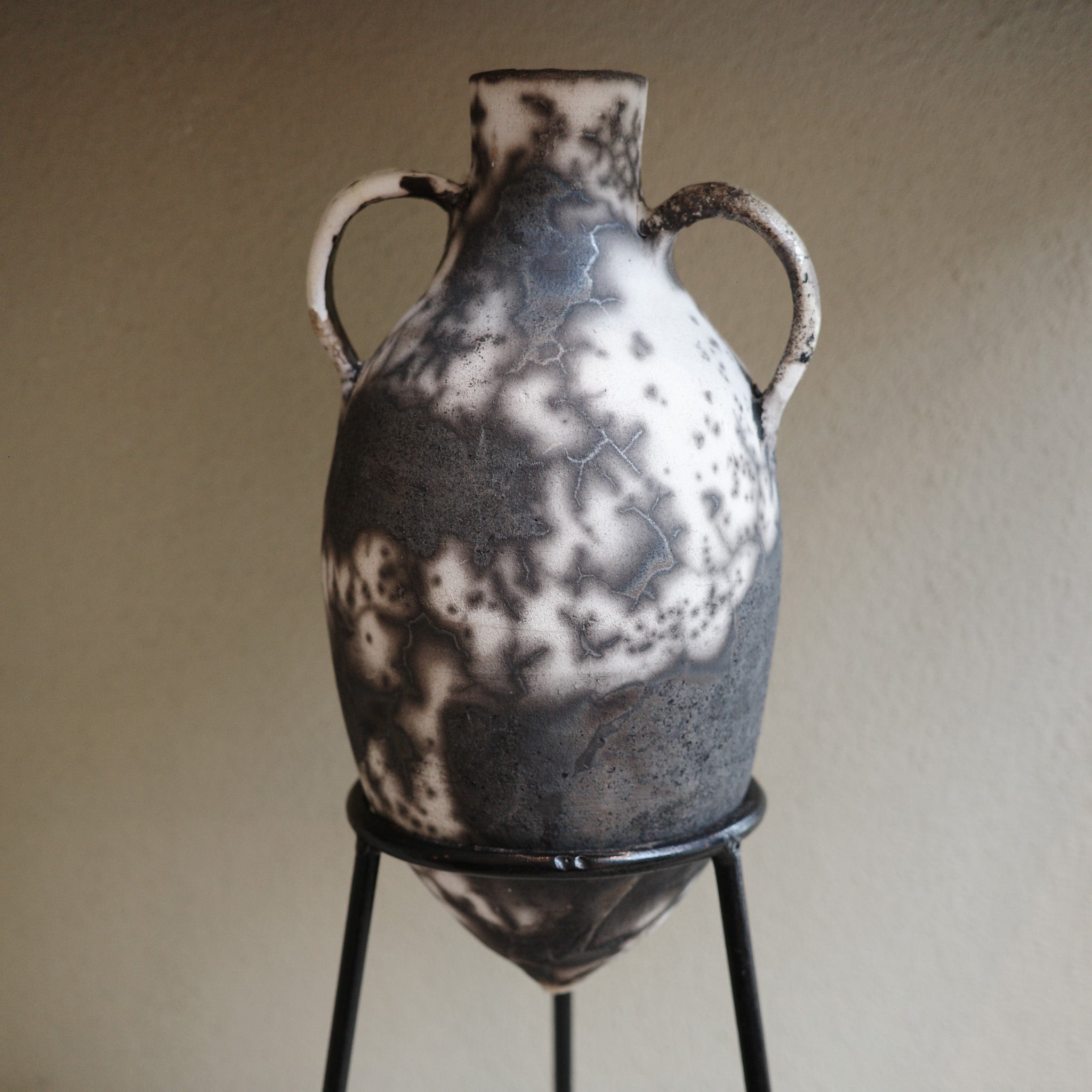 Detail of Naked Raku firing technique showing crackle glaze and smoke patterns on amphora vase