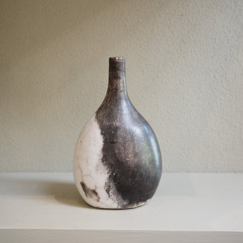 Unique ceramic bottle vase in Naked Raku firing technique, featuring organic smoke patterns.