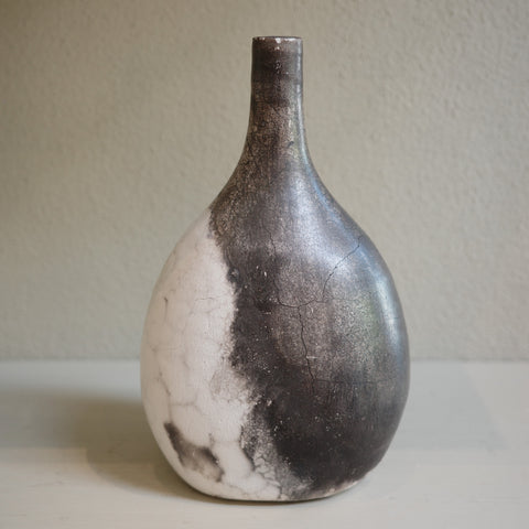 Unique ceramic bottle vase in Naked Raku firing technique, featuring organic smoke patterns.