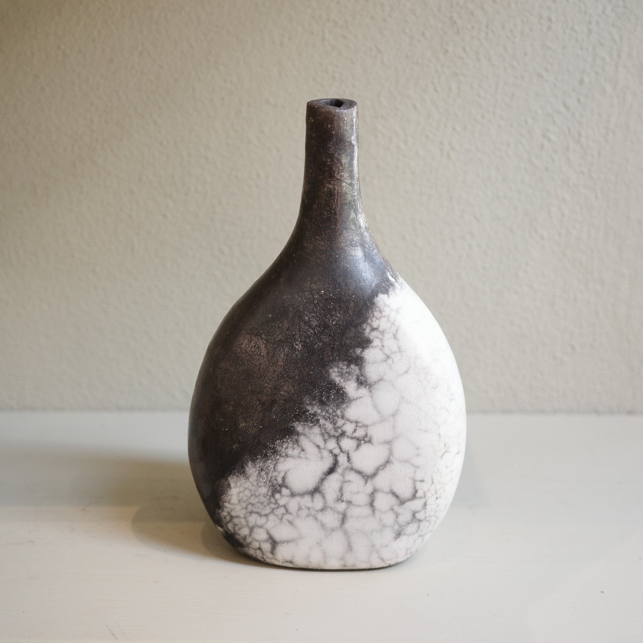 Artisan Naked Raku ceramic vase in black and white tones, one-of-a-kind decorative piece.