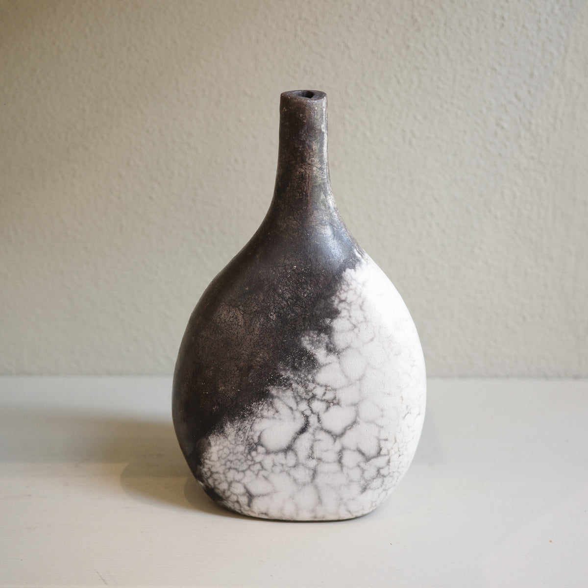 Artisan Naked Raku ceramic vase in black and white tones, one-of-a-kind decorative piece.