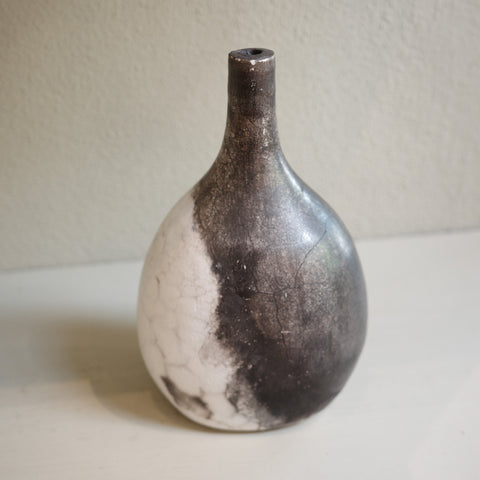 Unique ceramic bottle vase in Naked Raku firing technique, featuring organic smoke patterns.