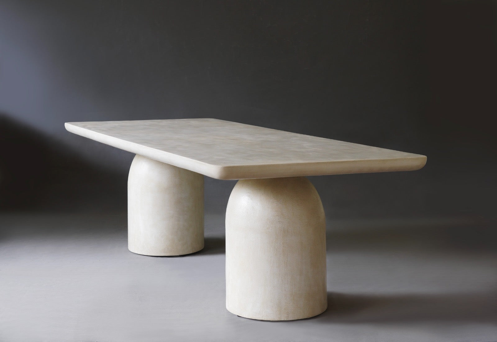 Side view of Nexus Dining Table in Oyster finish, highlighting its minimalist design.