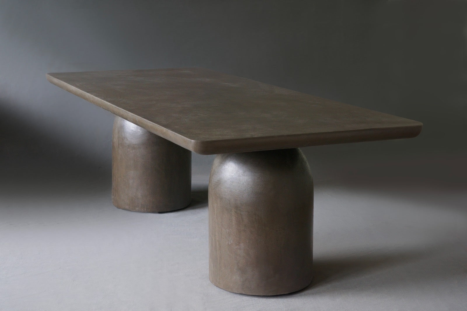 Side view of Nexus Dining Table in Pebble finish, highlighting its minimalist design.