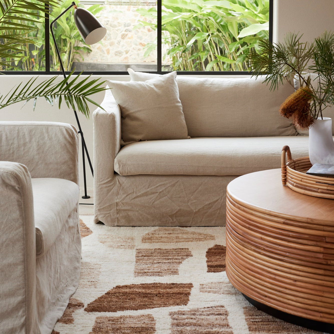 Close-up view of the Palma Coffee Table styled in a modern coastal living room setting