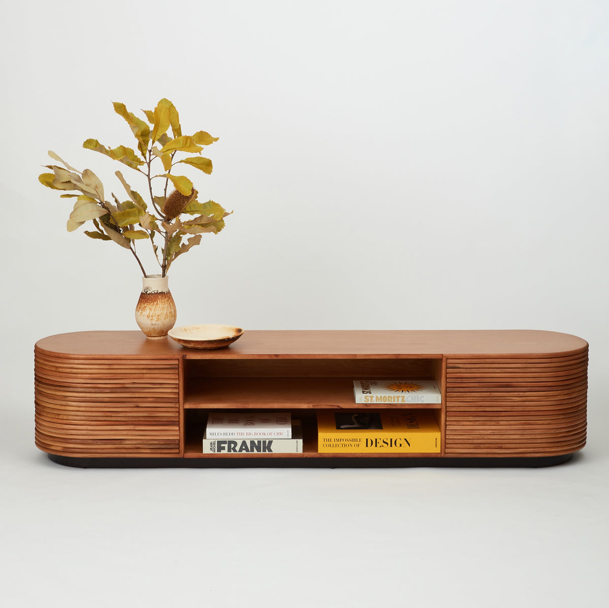 Panama rattan entertainment unit styled in a modern living room, concealing tech clutter and displaying books and décor.