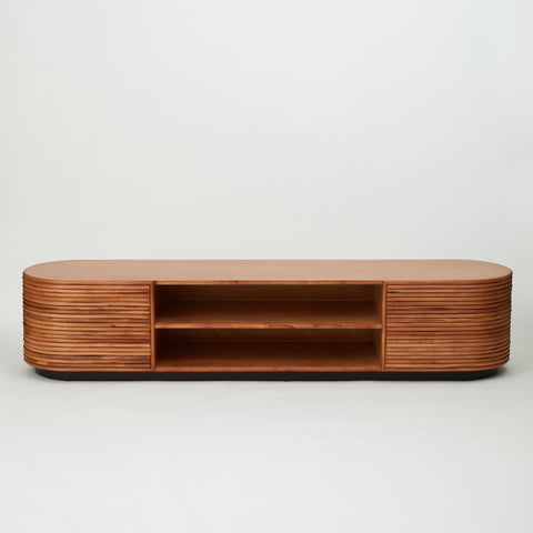Panama rattan entertainment unit with stacked rattan cladding, golden oak shelving, and walnut-stained base