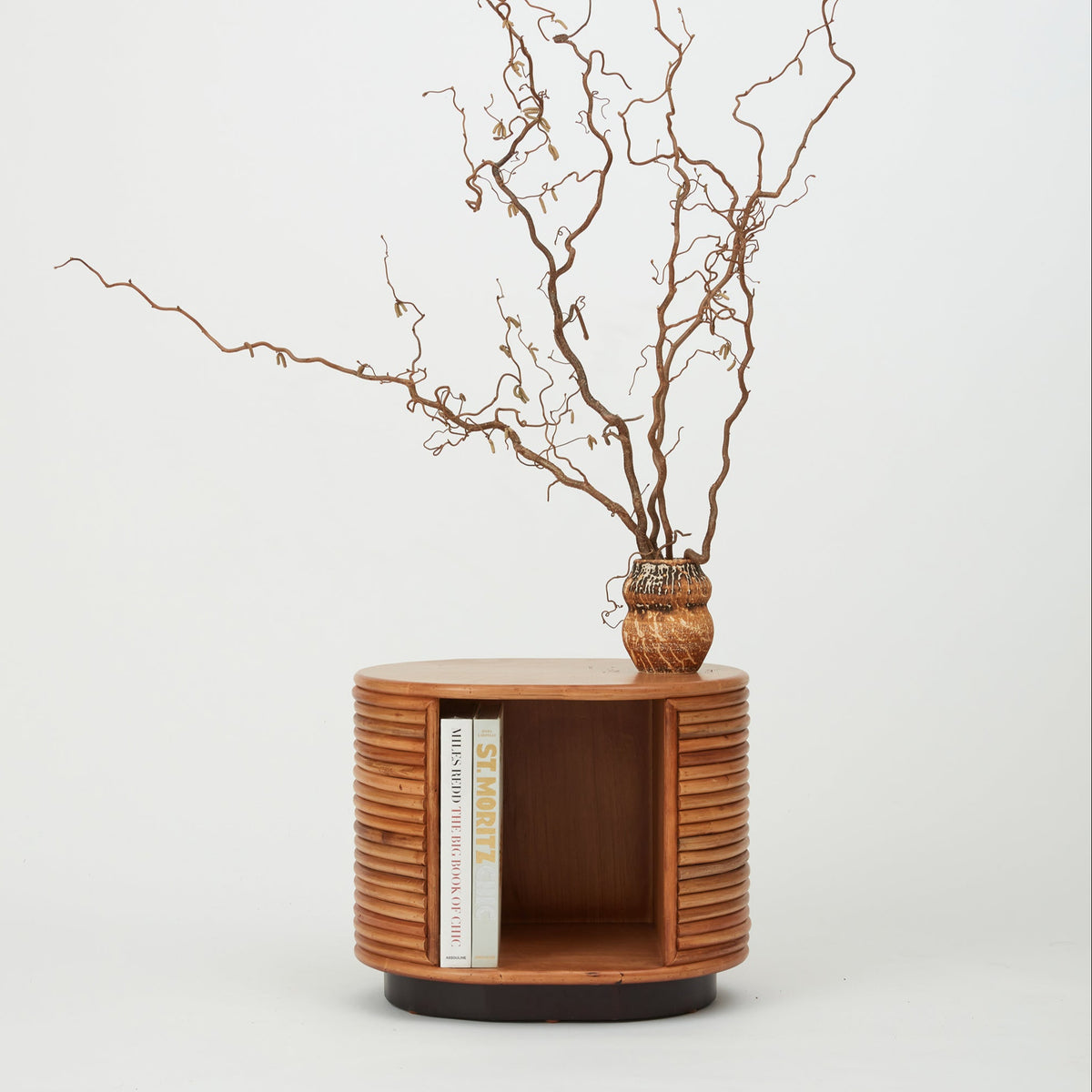 Panama oval rattan side table with open recessed shelf, natural finish.
