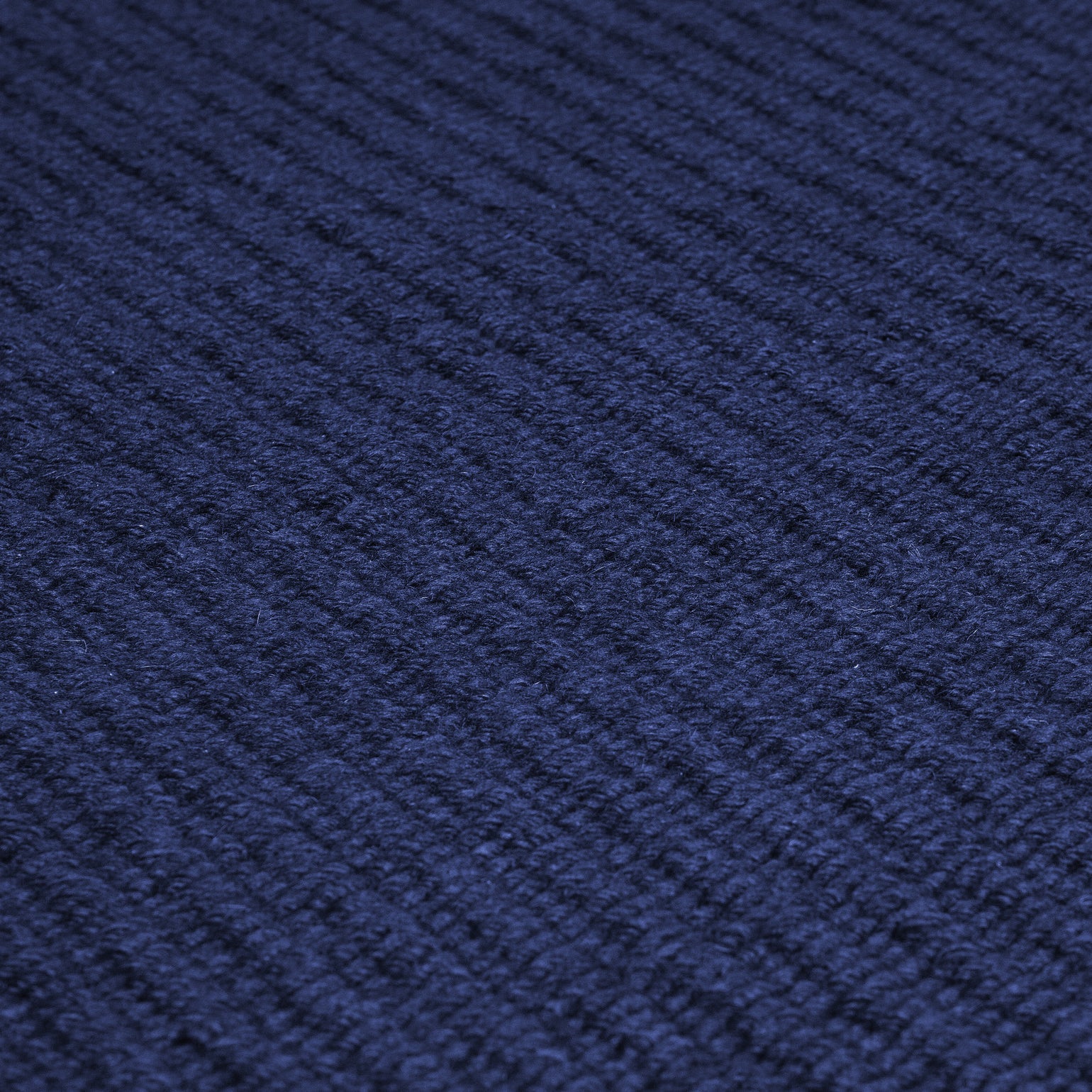 Close-up of the Pebble Flatweave Rug in Navy – handwoven New Zealand wool flatweave with subtle pebble-like texture.
