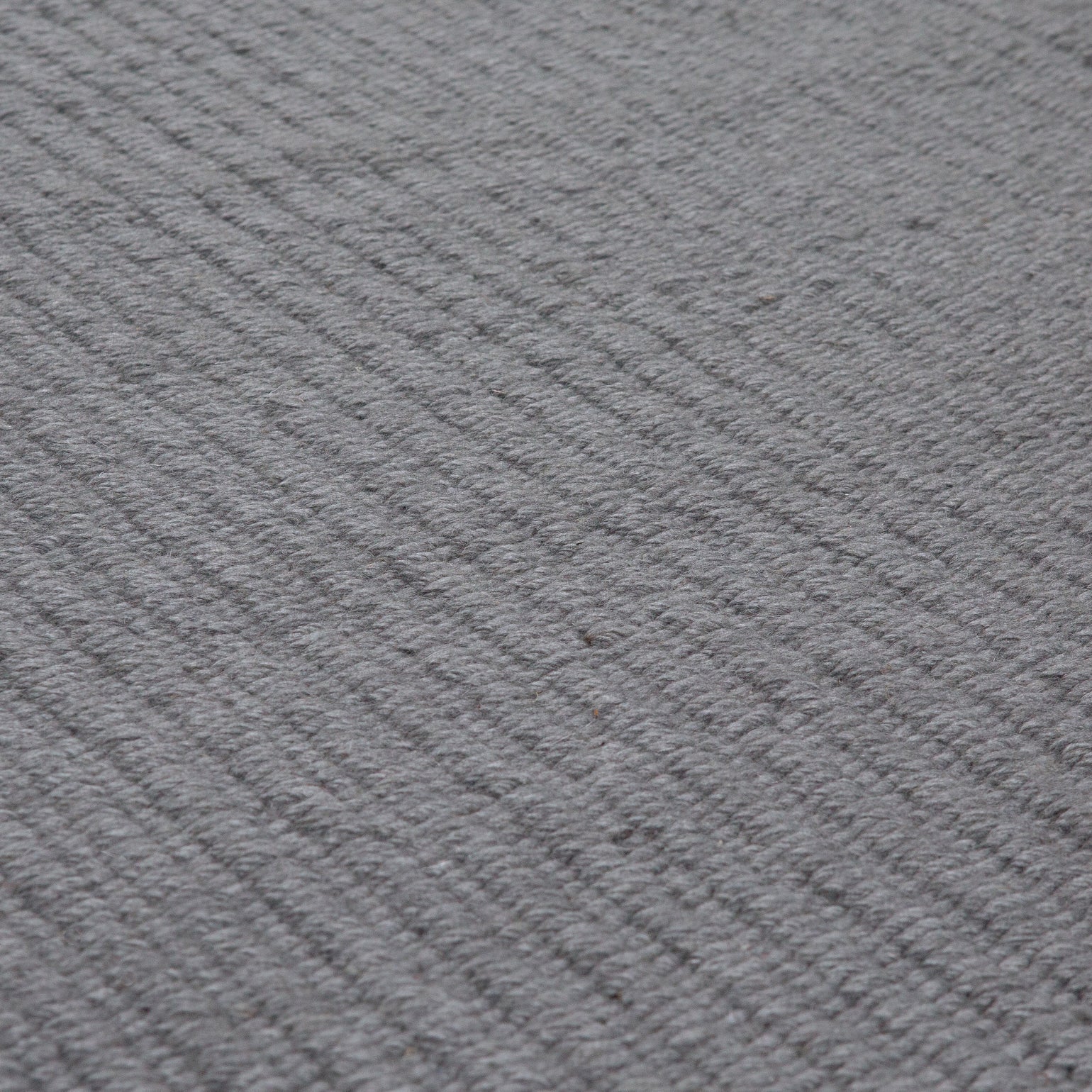 Pebble Flatweave Rug in Anthracite  Grey– handwoven New Zealand wool flatweave with subtle pebble-like texture.