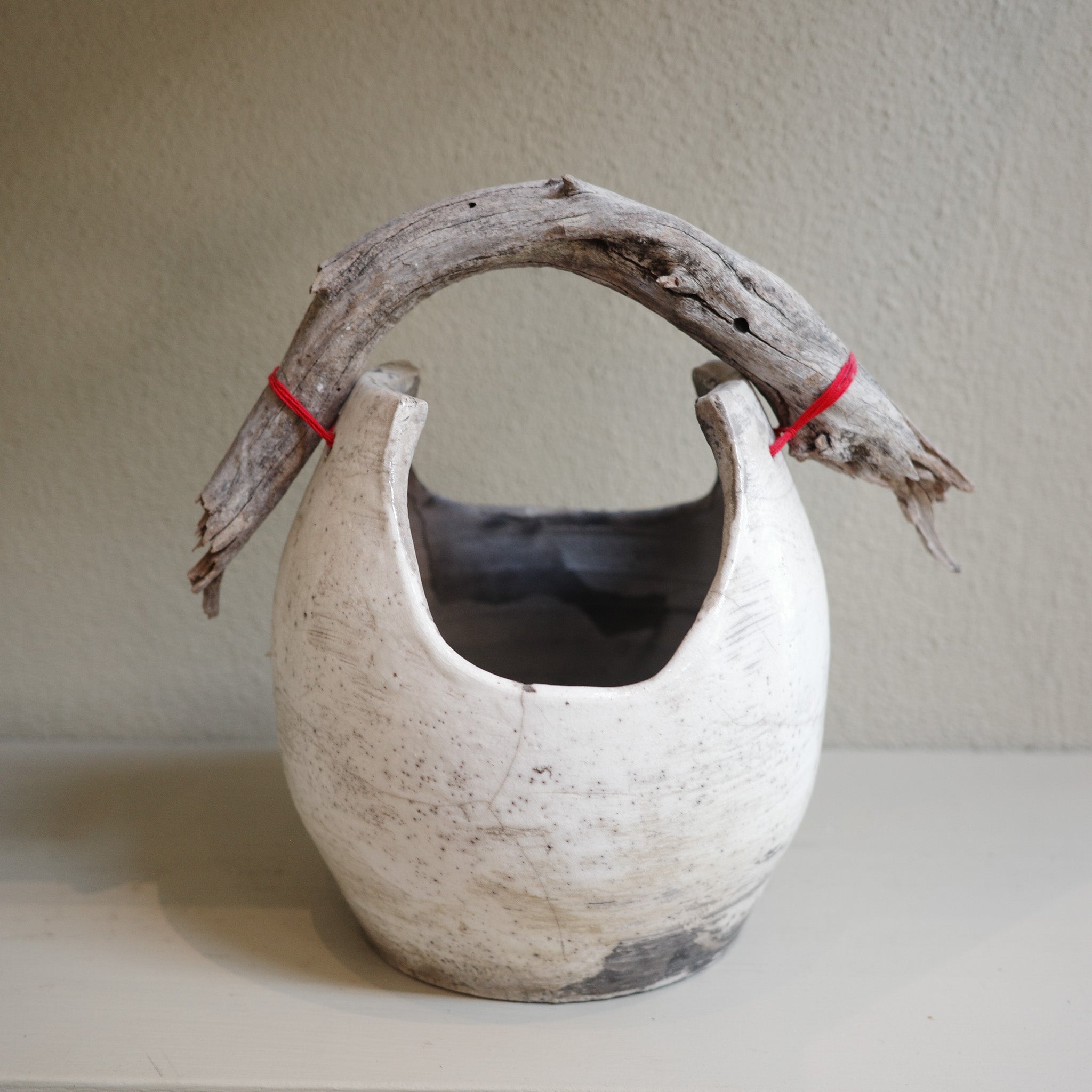 Handmade Raku ceramic vase with driftwood handle 