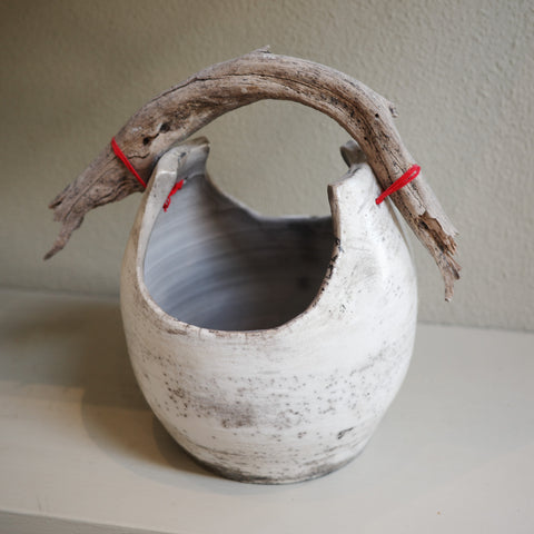 Handmade Raku ceramic vase with driftwood handle – angle view
