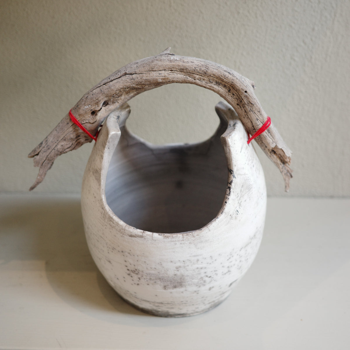 Handmade Raku ceramic vase with driftwood handle – front view
