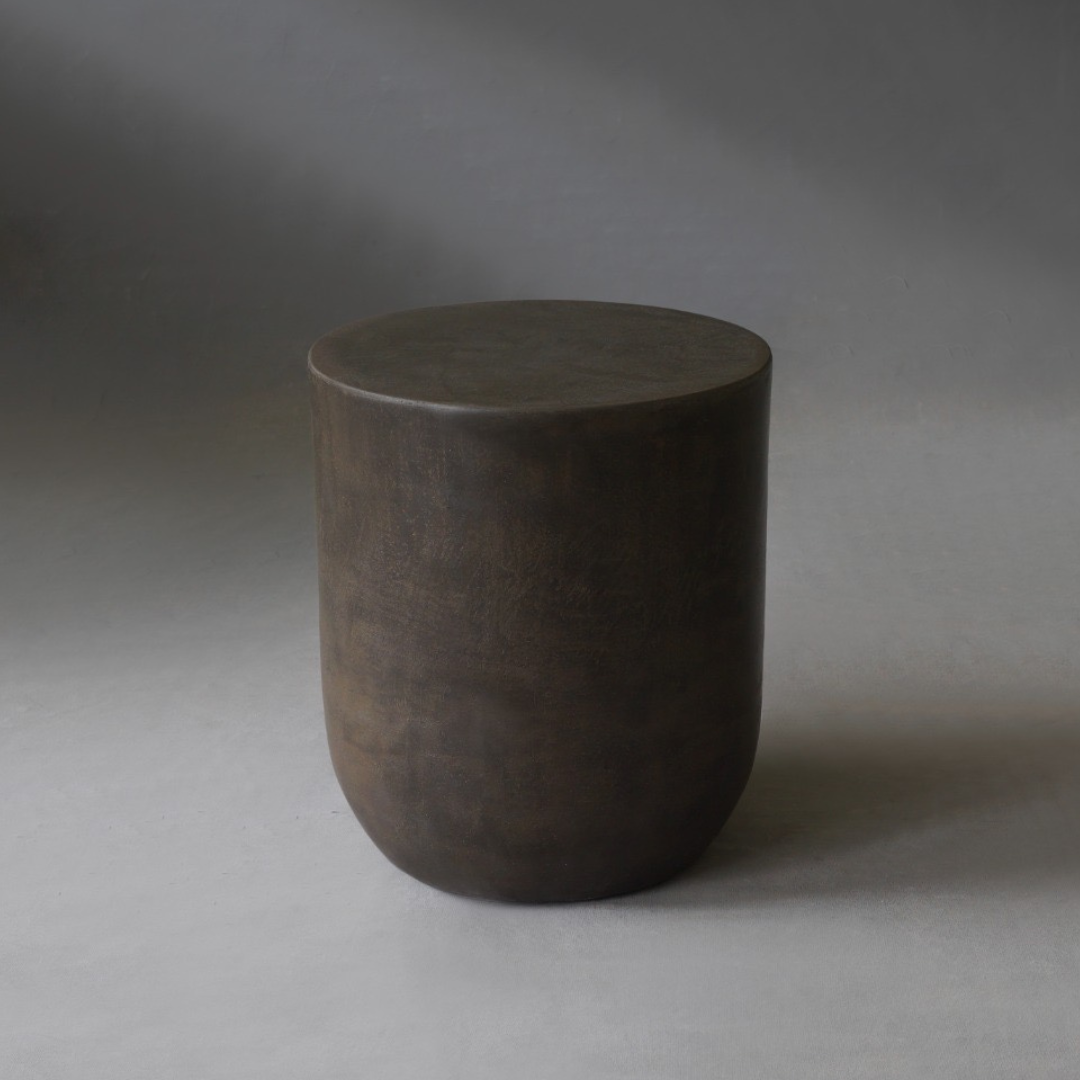 Remi Side Table in Pebble micro cement finish, highlighting its round shape and smooth texture.