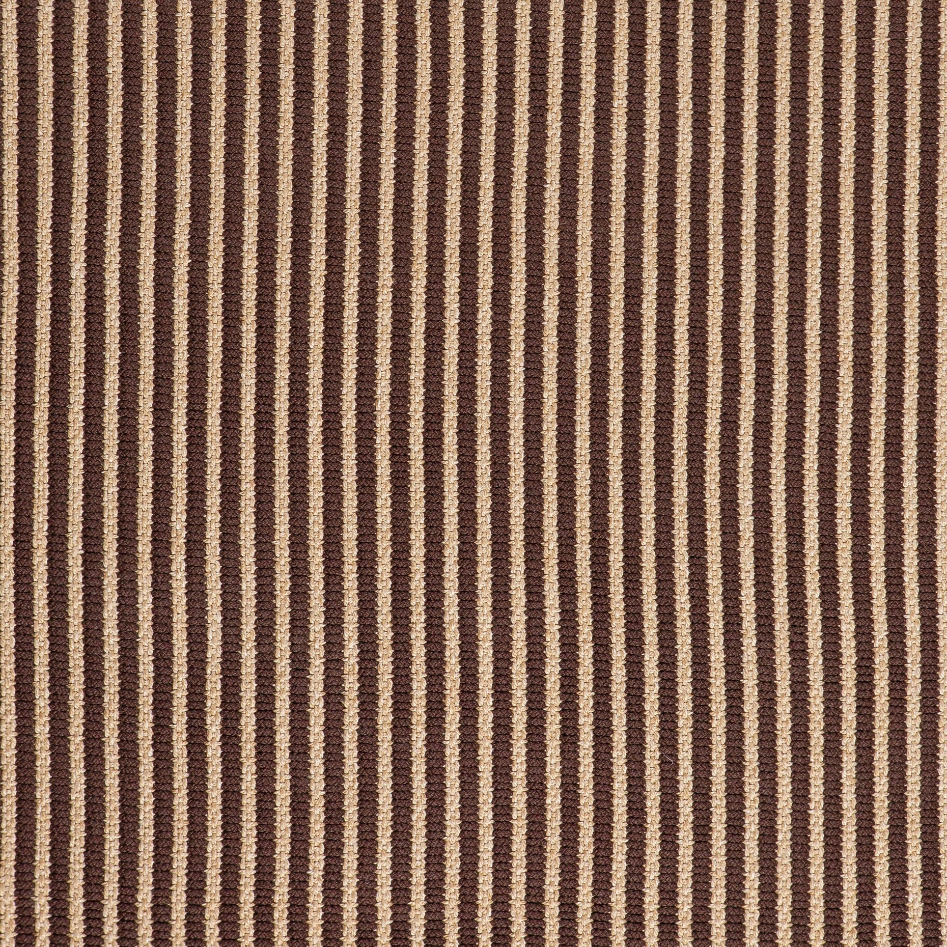 Close-up of textured ribbed brown and beige weave on outdoor rug