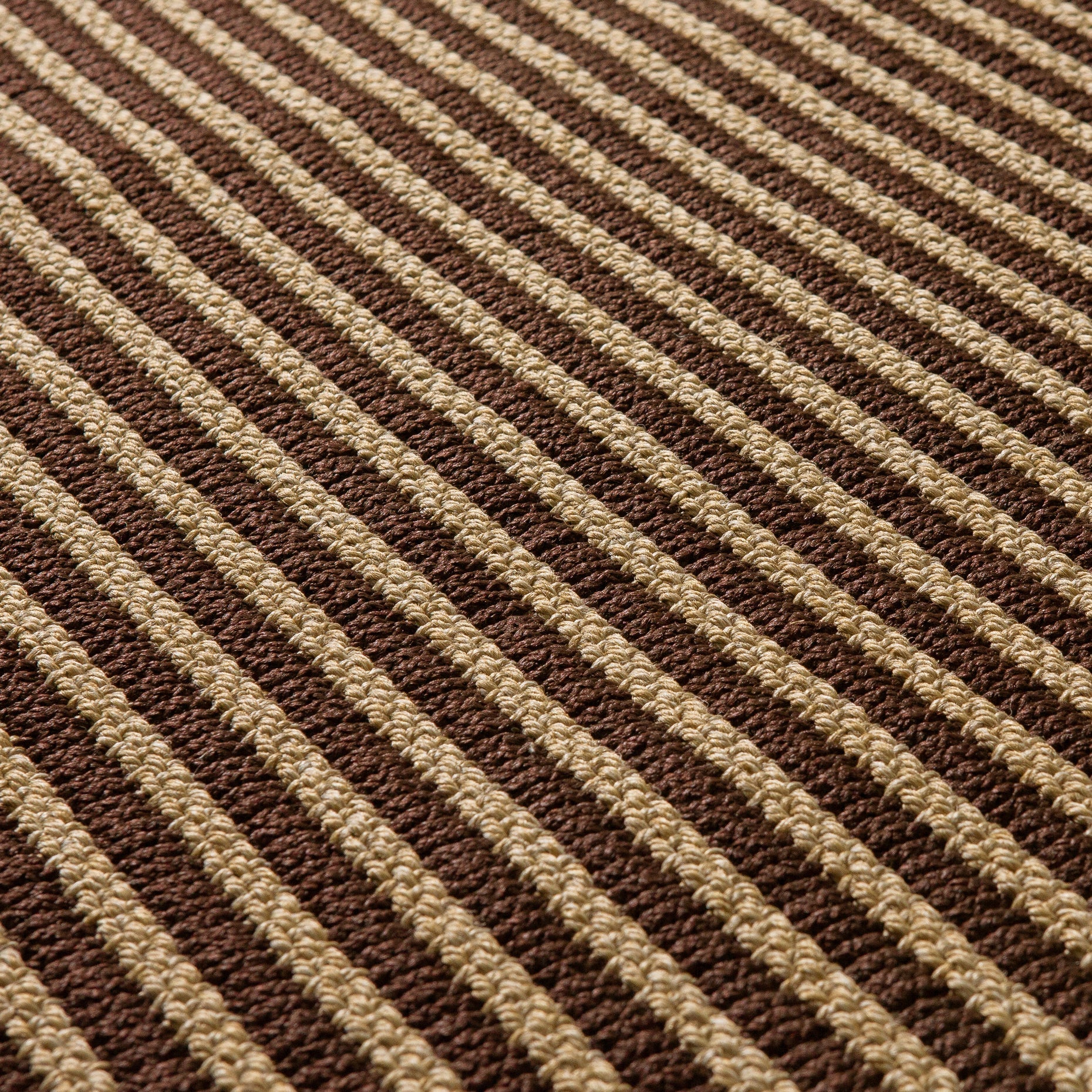 Close-up of textured ribbed brown and beige weave on indoor-outdoor rug