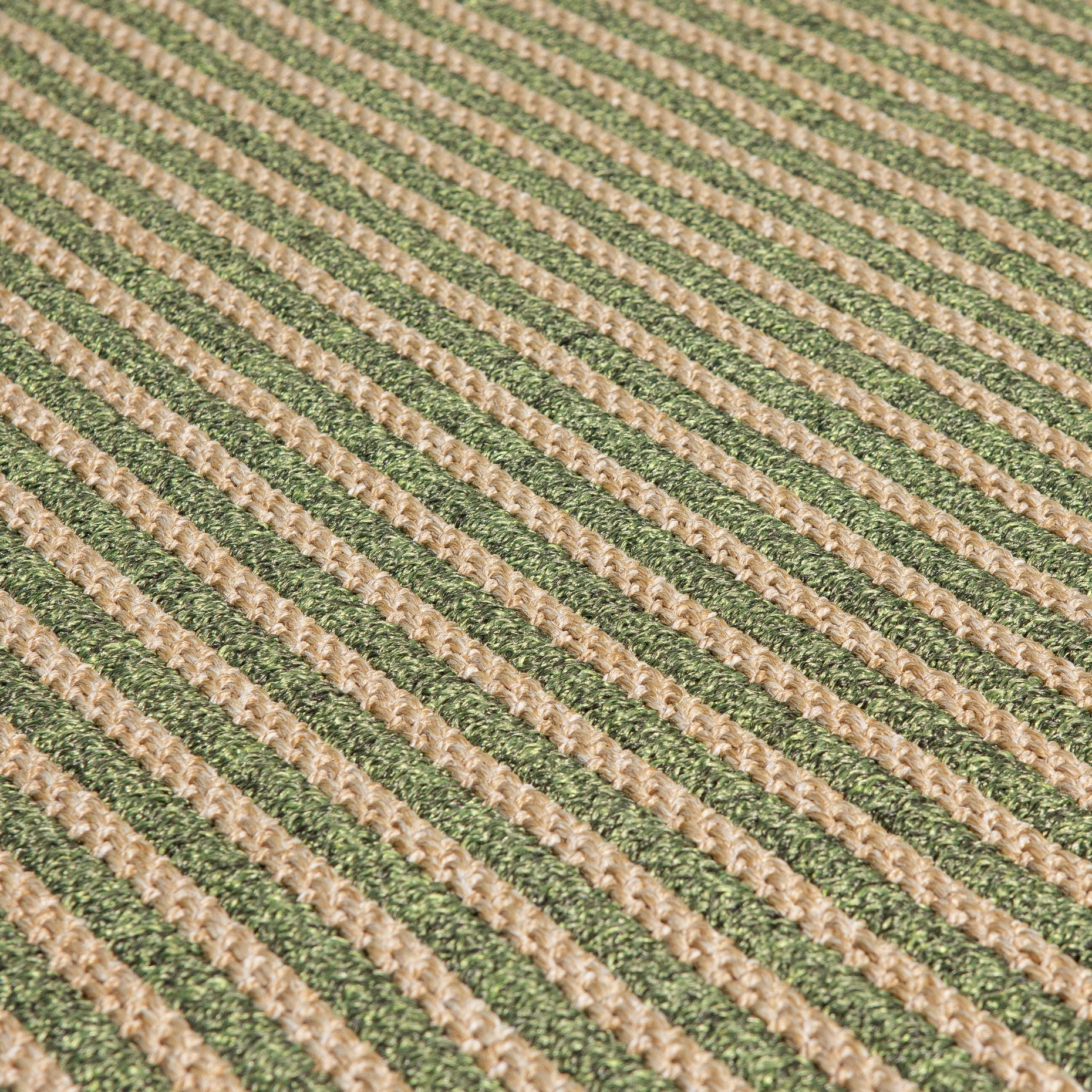 Close-up of textured ribbed green and beige weave on outdoor rug
