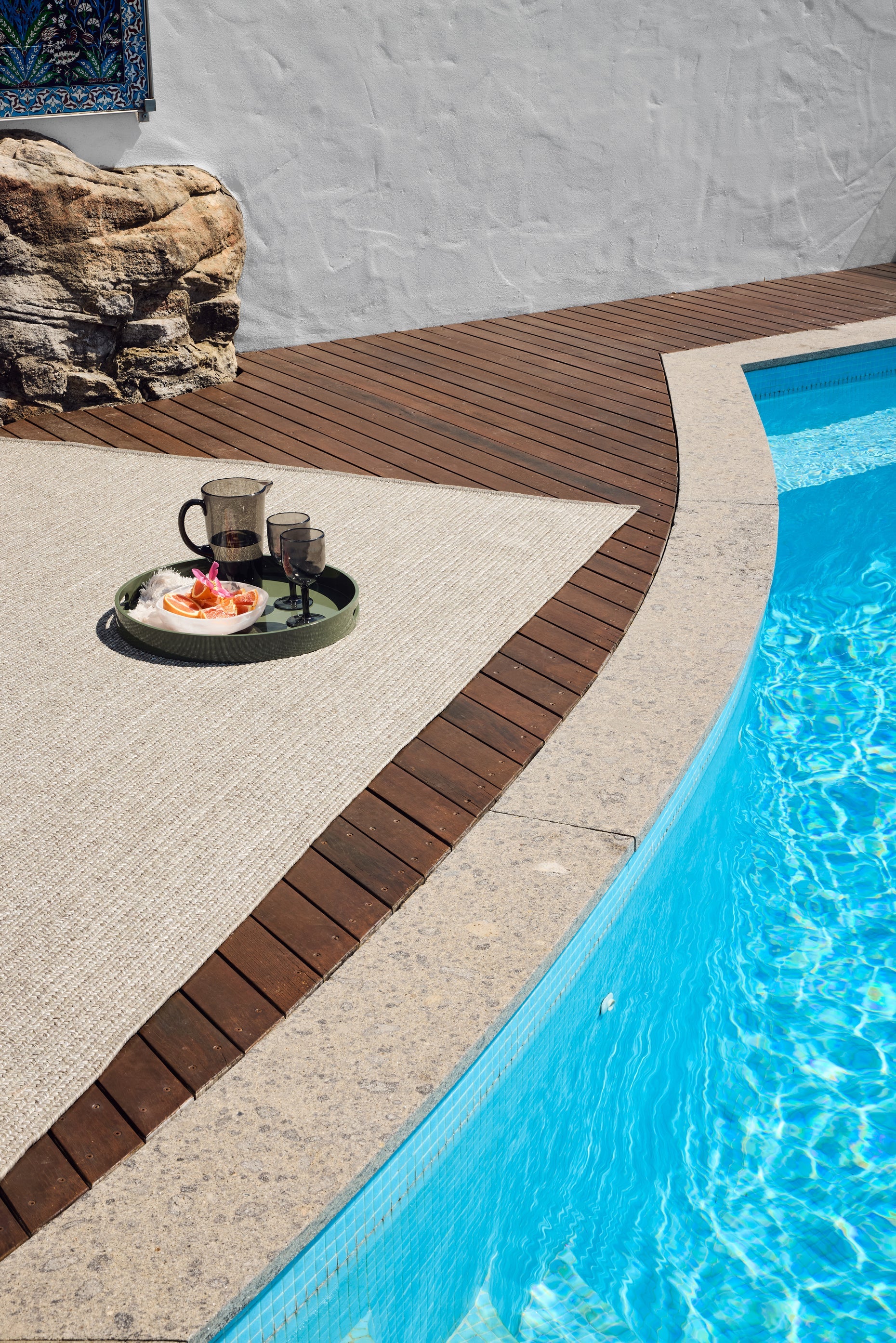 Seasons Natural Grey Stripe Rug near a pool