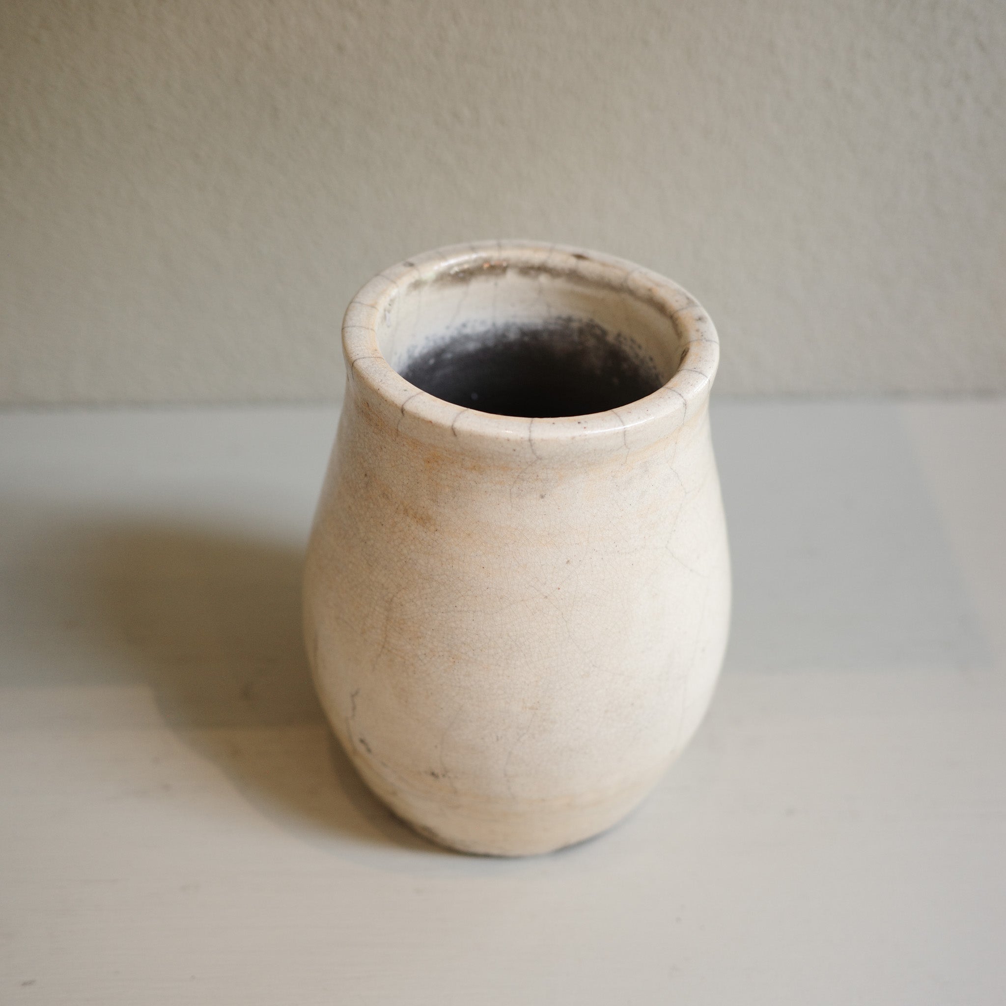Handmade small Raku vase with subtle orange markings and crackle glaze – artisanal ceramic by Jacqui Sosnowski.