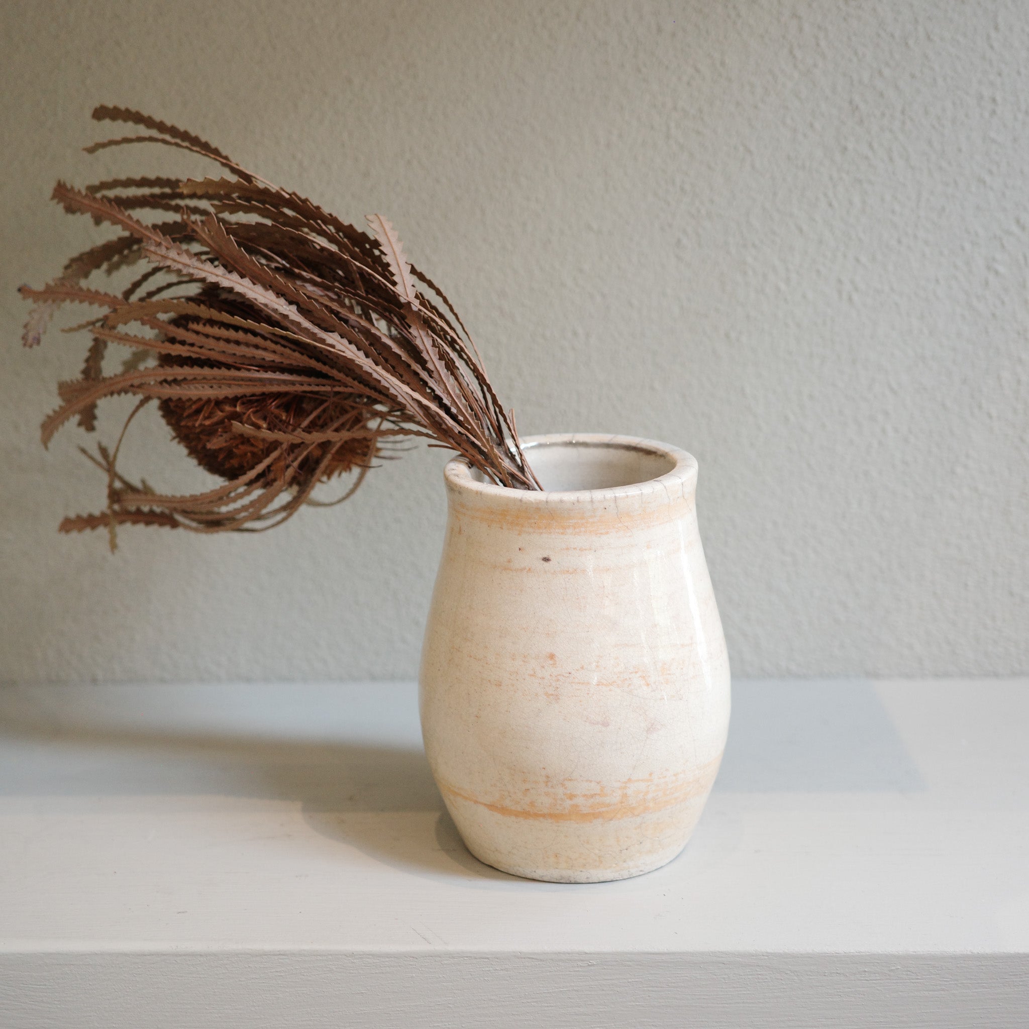 Handmade small Raku vase with subtle orange markings and crackle glaze – artisanal ceramic by Jacqui Sosnowski.