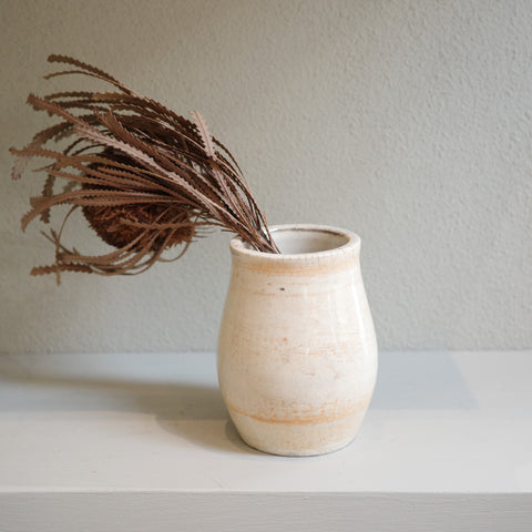 Handmade small Raku vase with subtle orange markings and crackle glaze – artisanal ceramic by Jacqui Sosnowski.