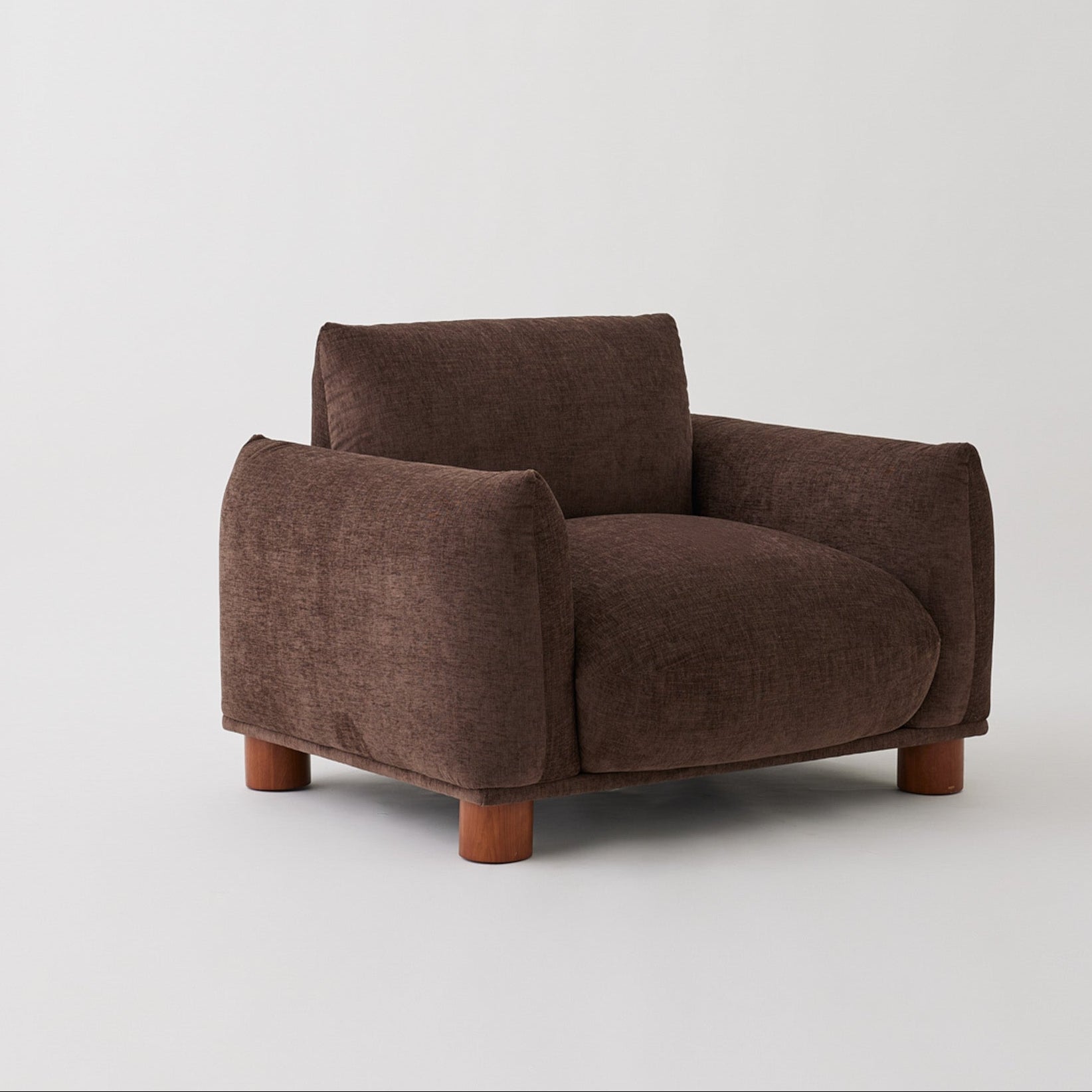 Side view of the Sumi armchair in Mocha